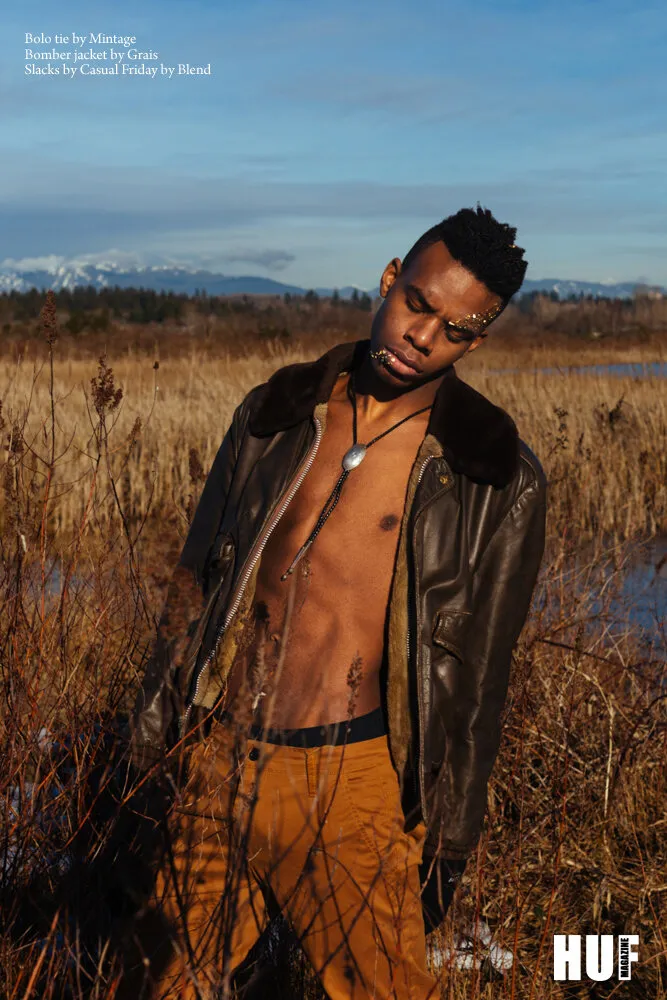 HUF Magazine editorial: model in a shearling-collared leather jacket standing in winter grassland